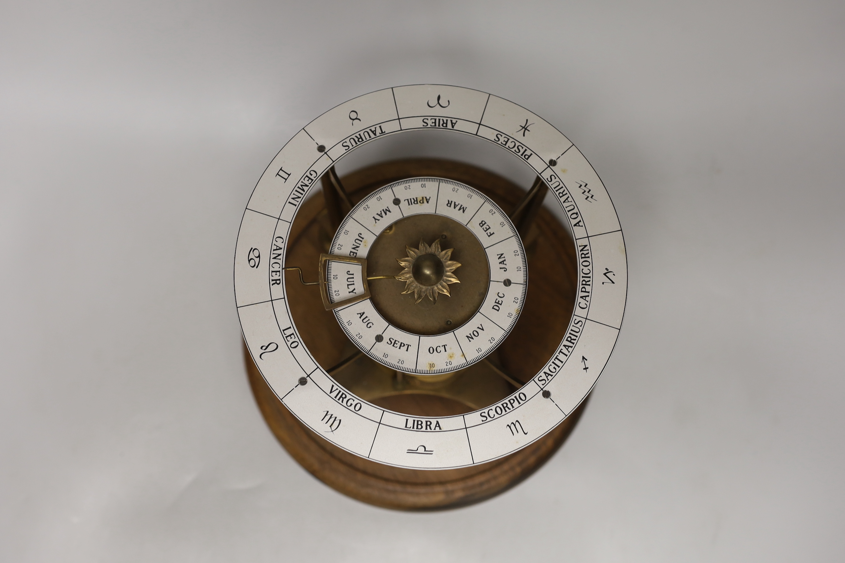 A circular novelty calendar timepiece, 20cm high